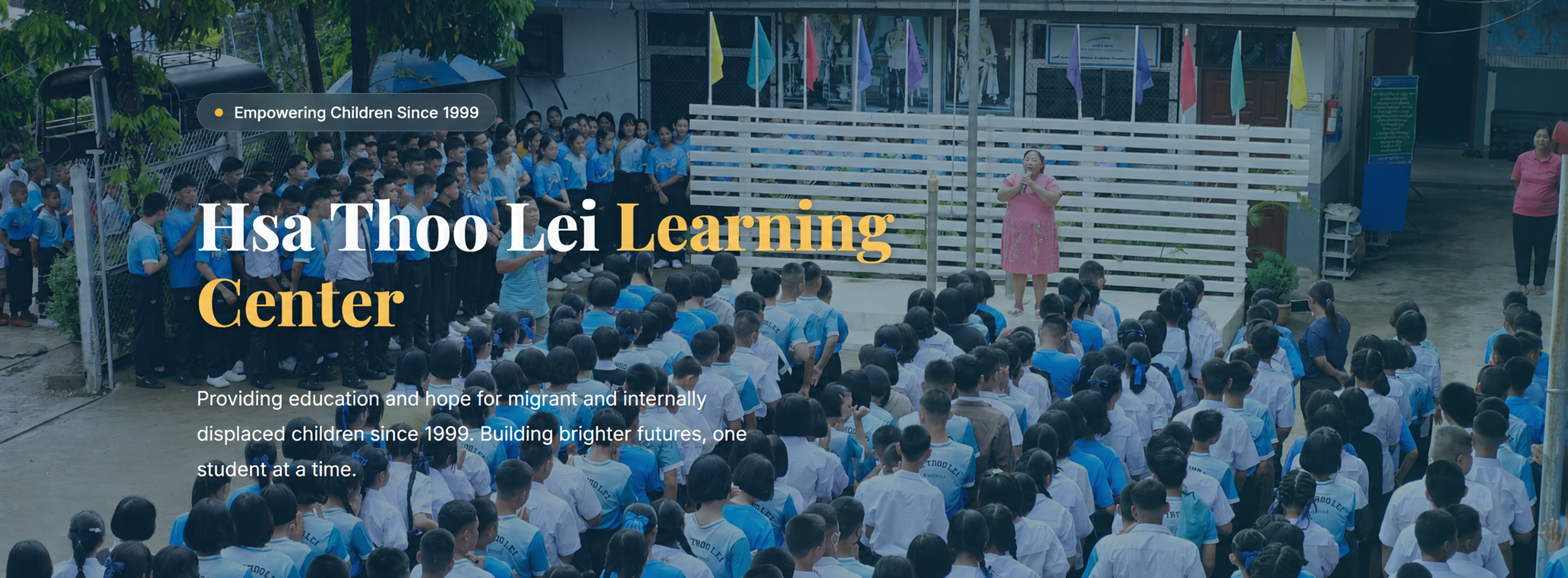 Hsa Thoo Lei students gathered at school with the message Empowering Children Since 1999